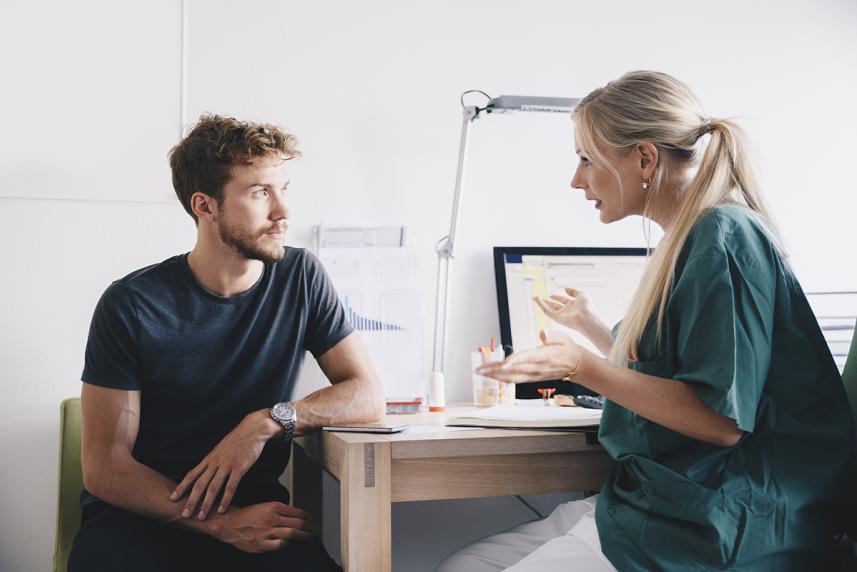 Man with doctor at annual checkup