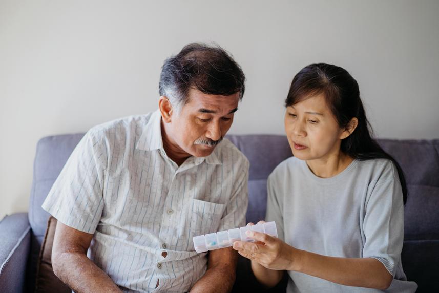 Caregiver explaining pill organizer instructions