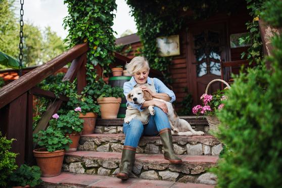 Woman holding dog on outdoor steps